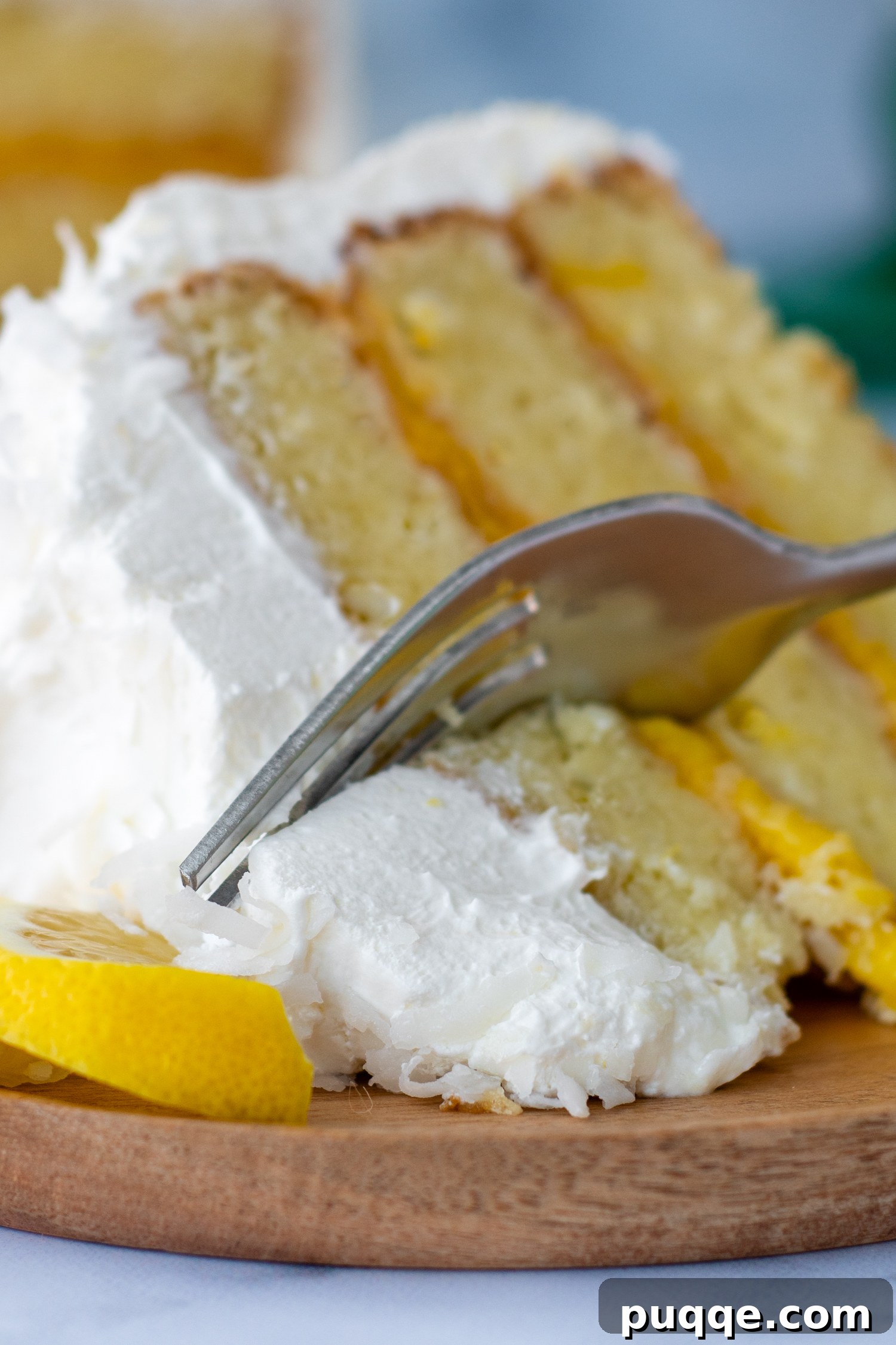Decadently Moist Gluten-Free Coconut Lemon Curd Velvet Cake 2 A perfectly sliced piece of gluten-free coconut lemon cake lying on its side, revealing its moist layers and lemon curd filling.