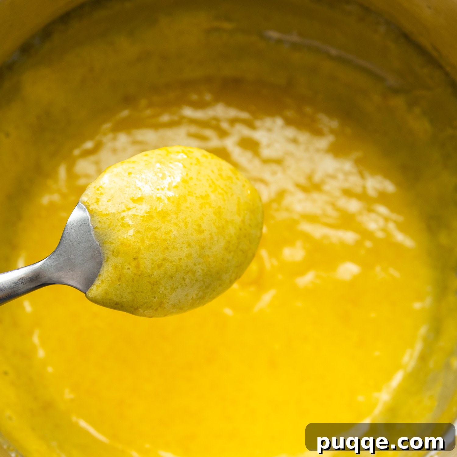 Decadently Moist Gluten-Free Coconut Lemon Curd Velvet Cake 4 Perfectly thickened lemon curd generously coating the back of a spoon, indicating it's ready.
