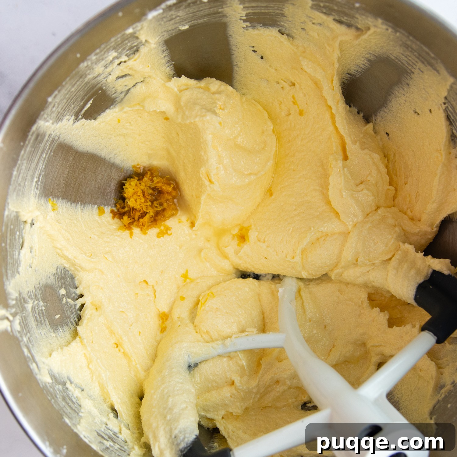 Decadently Moist Gluten-Free Coconut Lemon Curd Velvet Cake 5 Close-up of butter, oil, and sugar being creamed together in a mixing bowl, showcasing the light and fluffy texture.