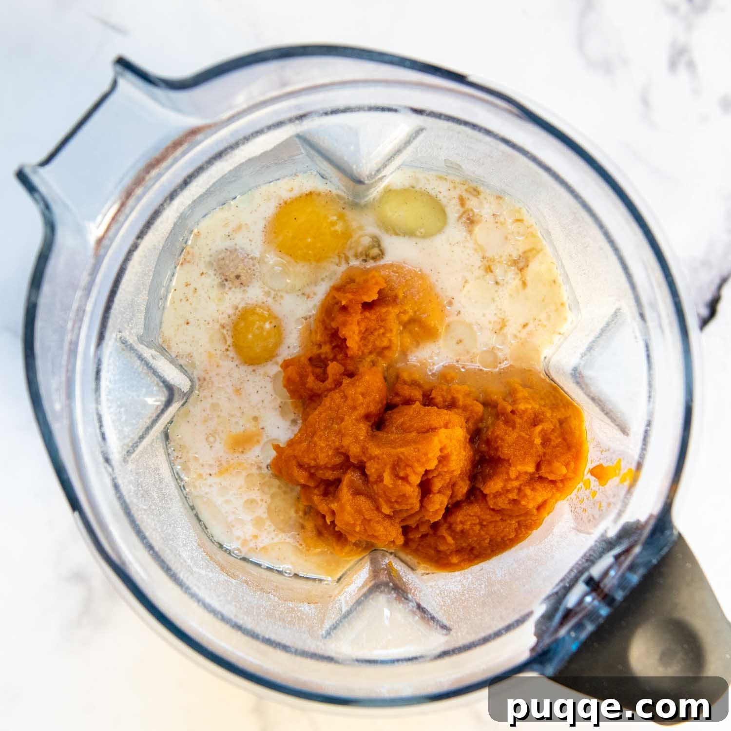 Fluffiest 5-Minute Pumpkin Oat Flour Muffins 5 pumpkin puree, along with other wet ingredients being added.