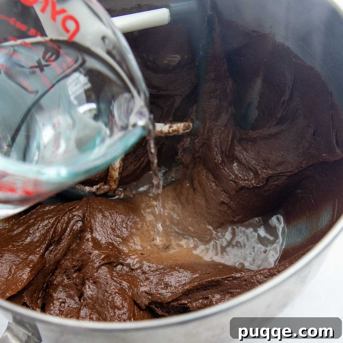 Decadently Moist & Easy Gluten-Free Chocolate Cake 4 Carefully pouring boiling water into the chocolate cake batter while mixing.