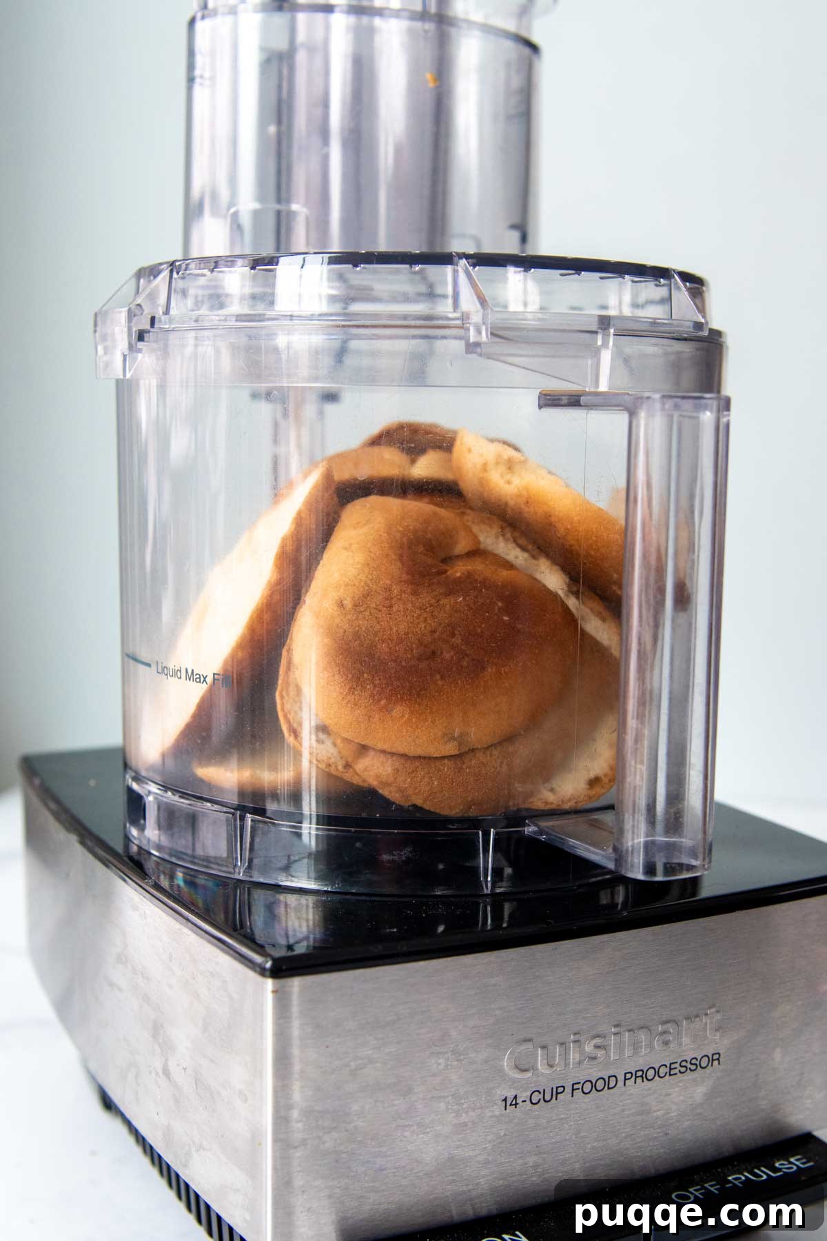 Whole slices of gluten-free bread being prepared in a food processor, ready to be transformed into breadcrumbs.
