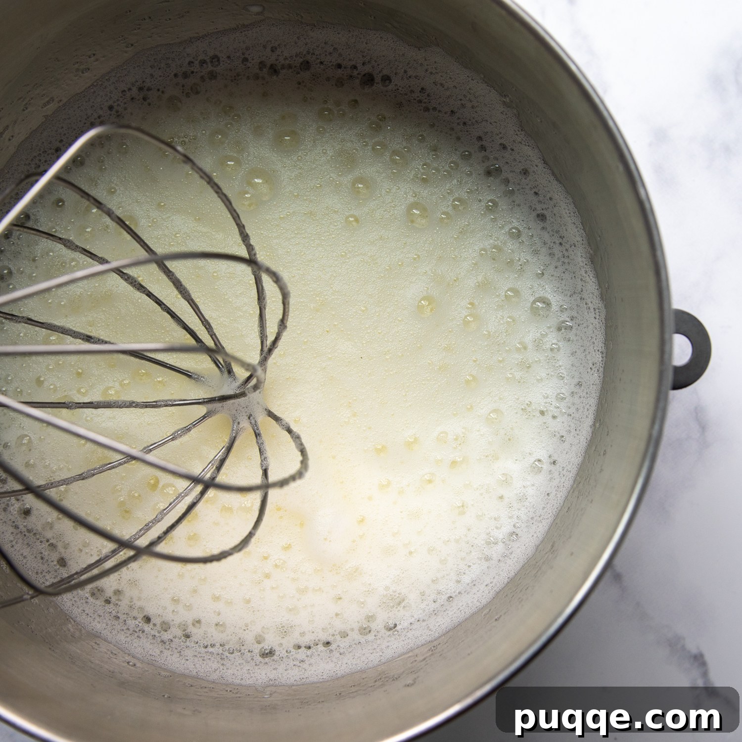Pillowy Soft Gluten-Free Angel Food Delight 5 Egg whites being beaten in a mixing bowl, showing the foamy stage.