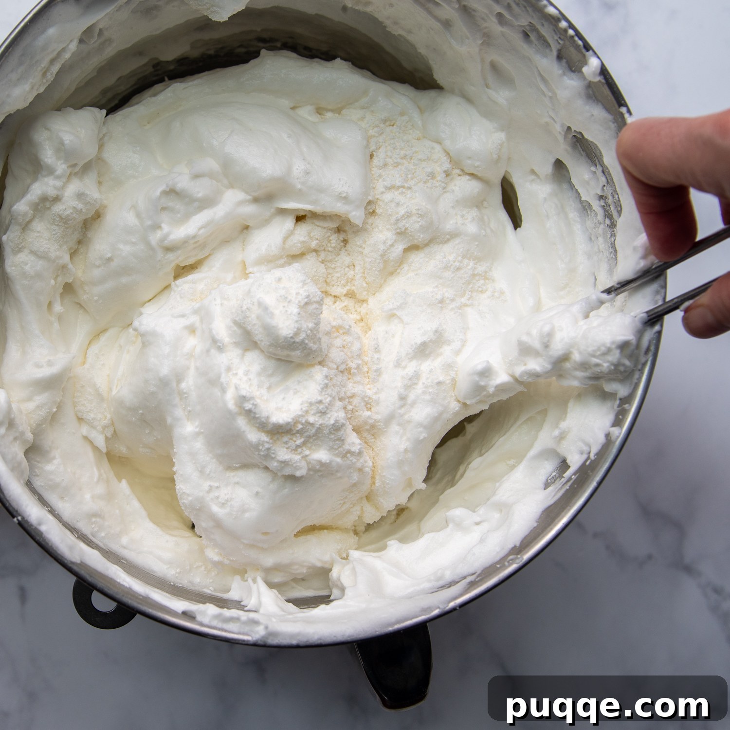 Pillowy Soft Gluten-Free Angel Food Delight 7 Gently folding dry ingredients into the prepared meringue.