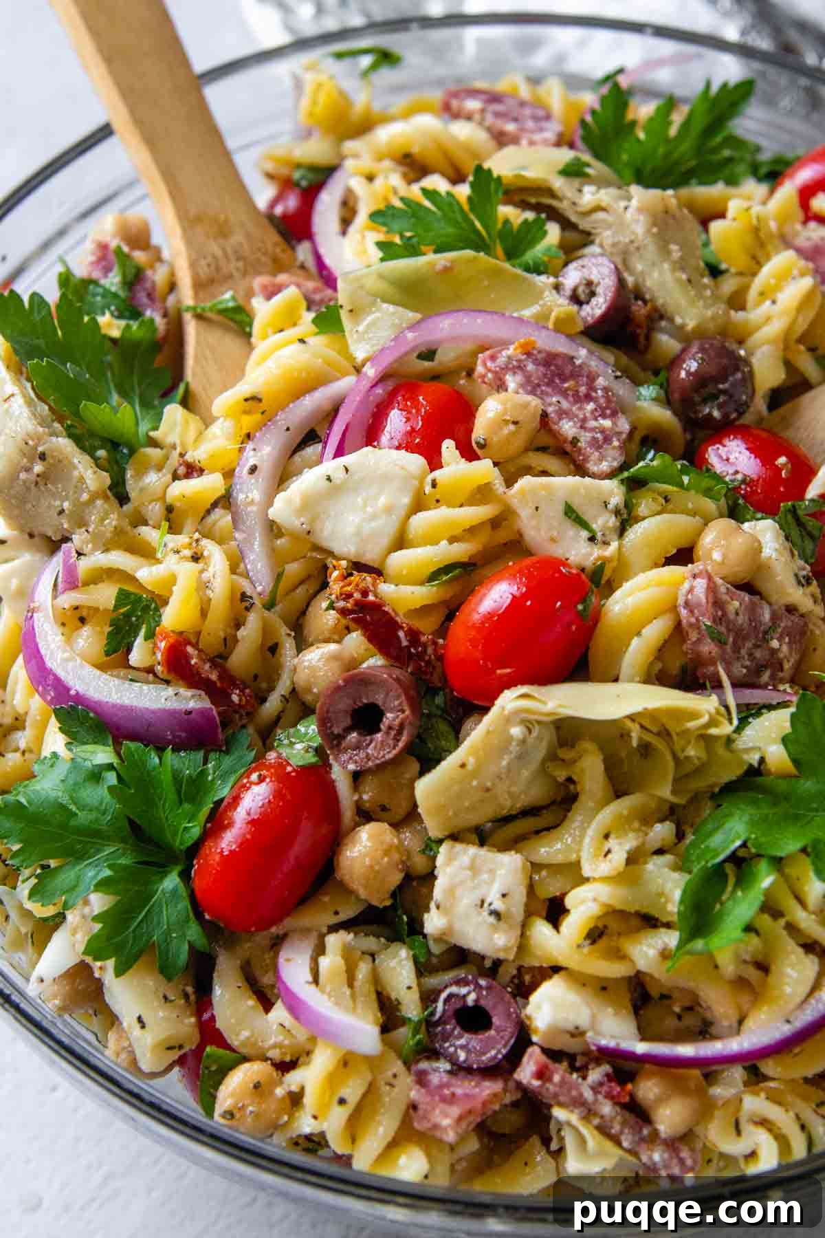 Vibrant Gluten-Free Pasta Salad with Sun-Dried Tomato Dressing 6 close up of gluten-free pasta salad in glass bowl, showing texture and detail.