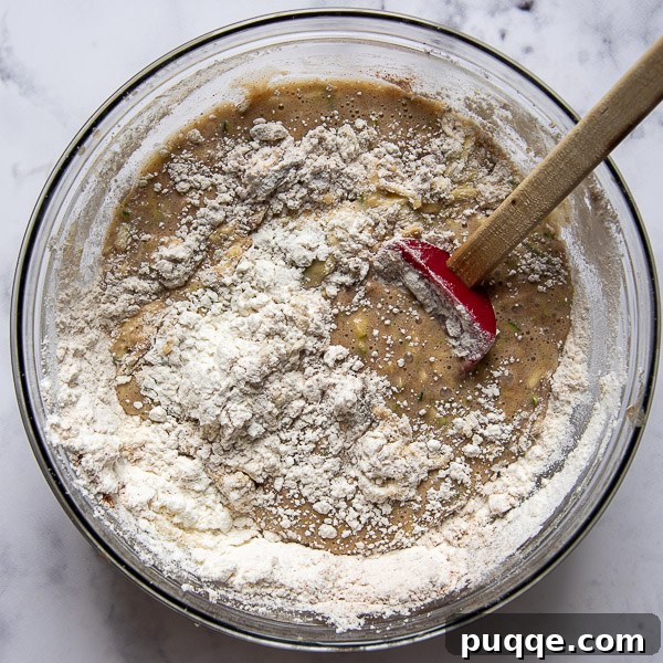 Seriously The Best Gluten Free Zucchini Bread Incredibly Moist 5 Gluten-free flour and spices being stirred into the zucchini bread batter.