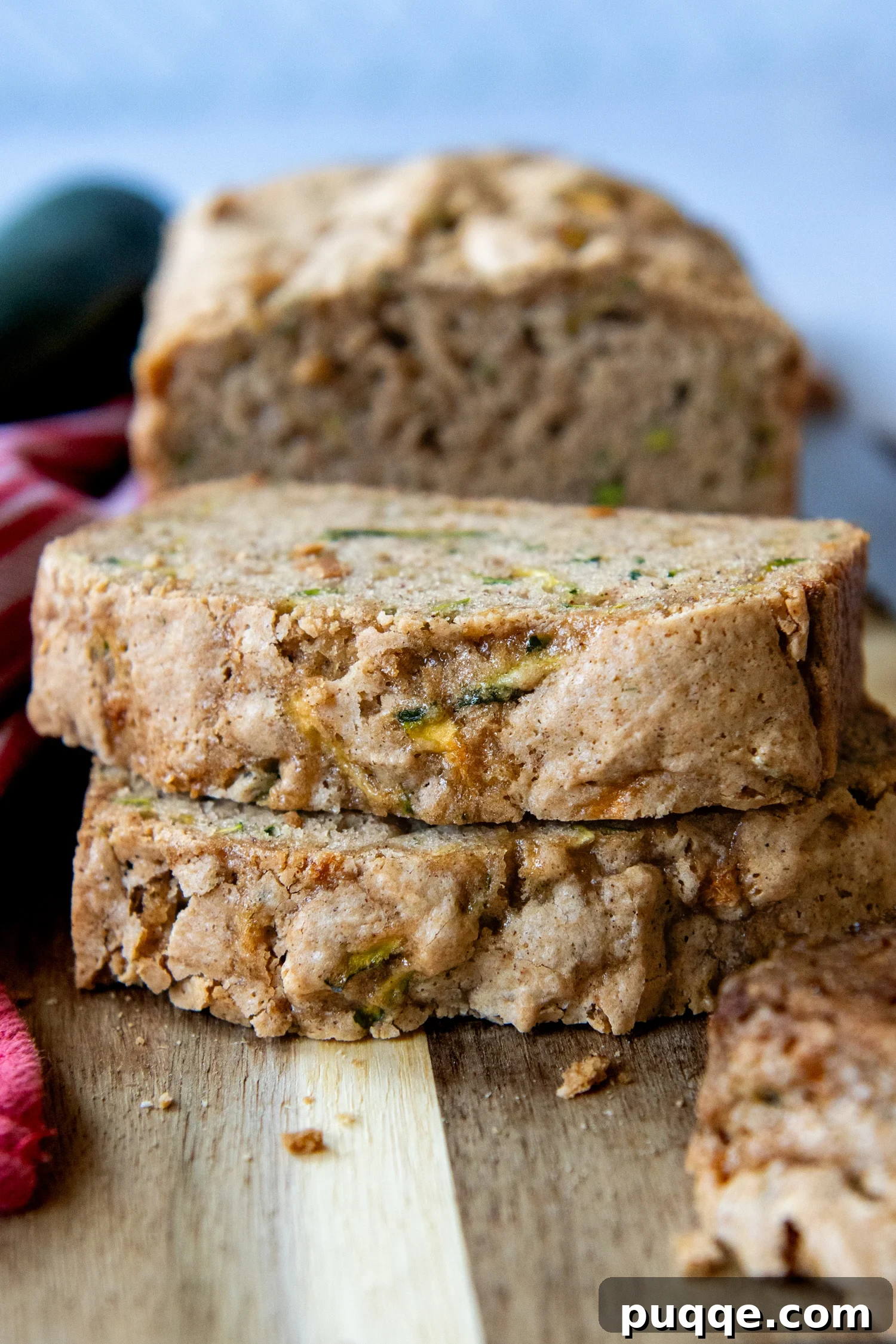 Seriously The Best Gluten Free Zucchini Bread Incredibly Moist 6 Two generous slices of moist gluten-free zucchini bread, stacked and ready to be enjoyed on a rustic wooden cutting board.