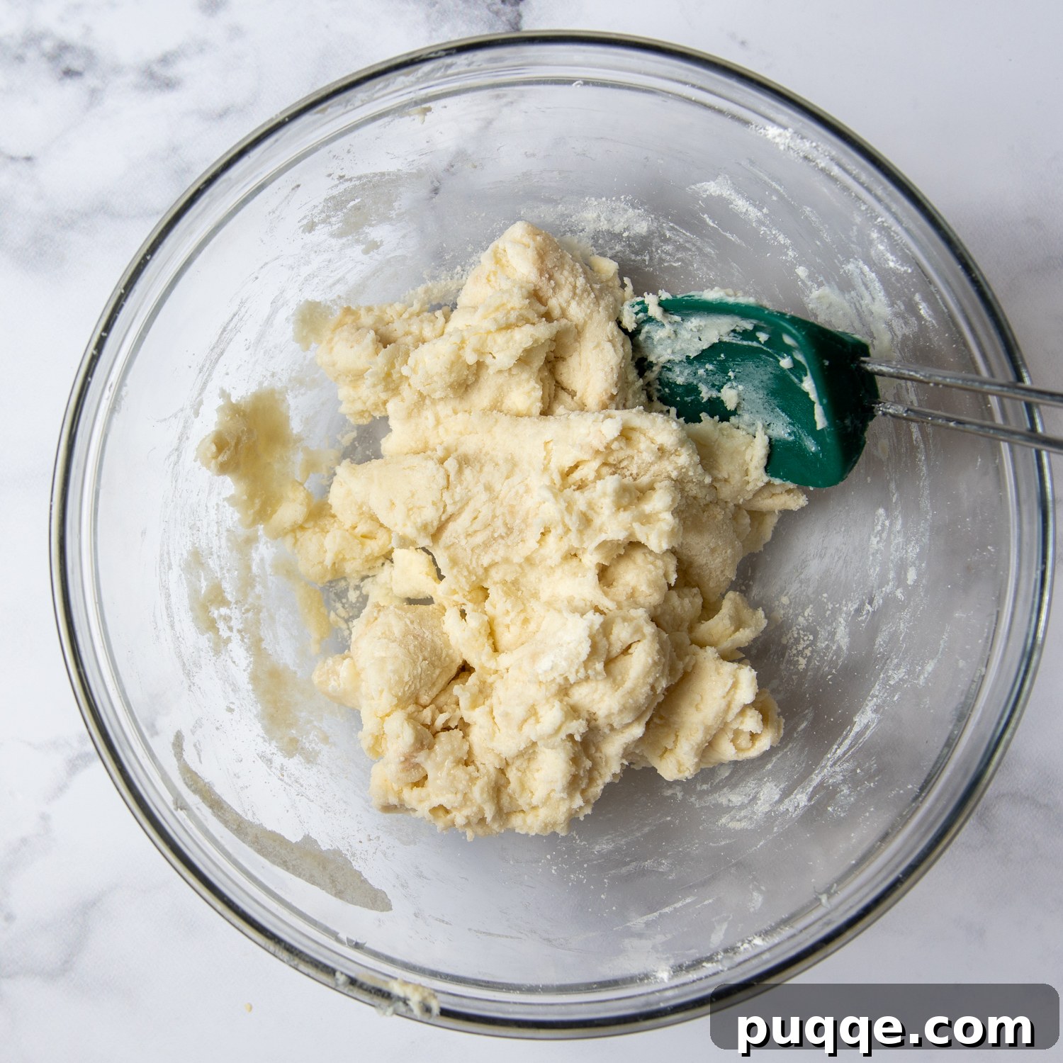 a soft cobbler dough formed in a glass bowl.
