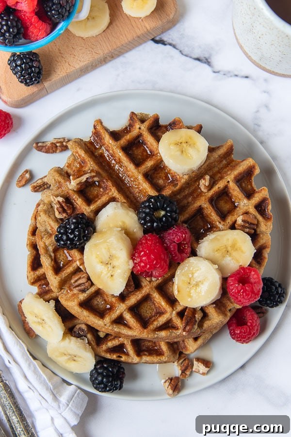 Wholesome Fluffy Gluten Free Banana Oatmeal Waffles 4 overhead shot of gluten free banana oatmeal waffles on a white plate
