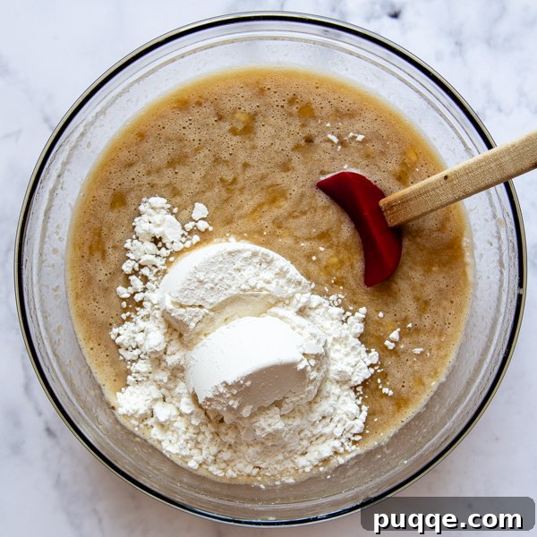a mixing bowl with the flour being stirred in.