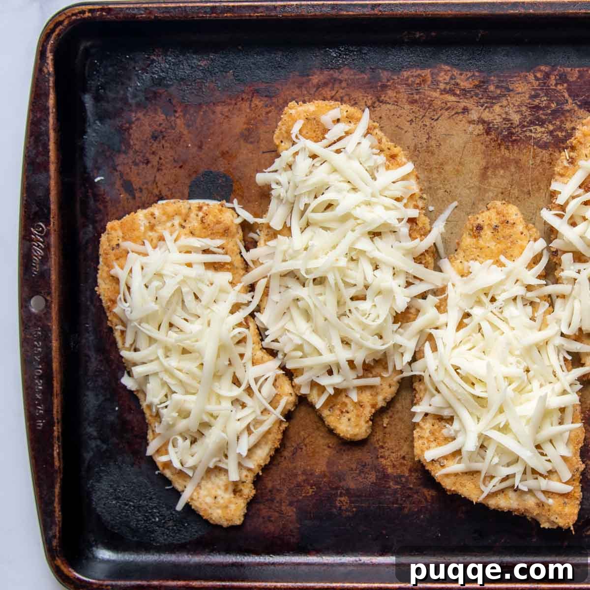 Oven-Crisp Gluten-Free Chicken Parmesan 5 baked chicken with mozzarella cheese on top.