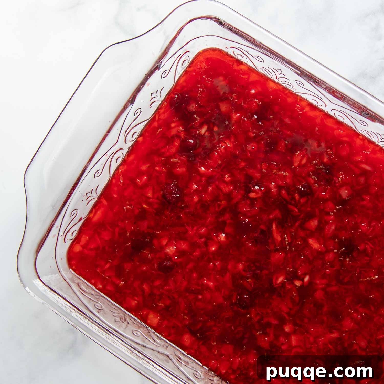 Classic Cranberry Raspberry Gelatin Mold 4 Cranberry jello setting in a glass dish, viewed from above.