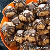 A plate of gluten-free Halloween spider cookies on a orange plate