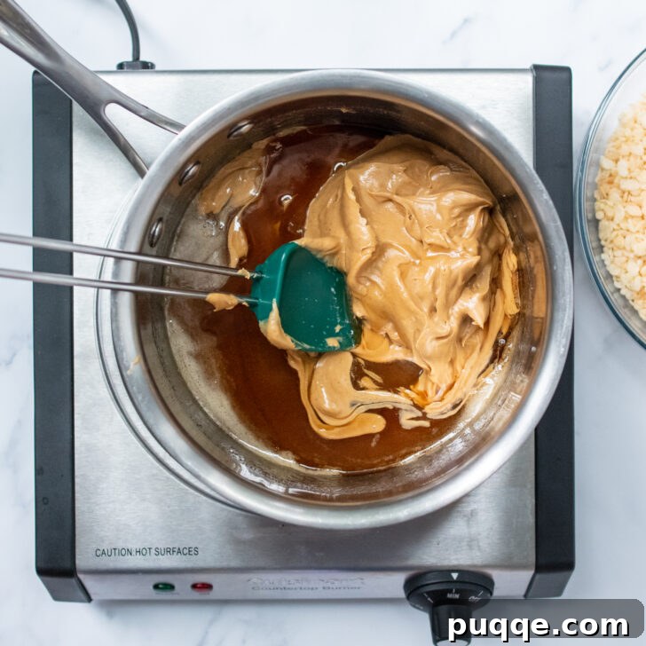 Ghoulishly Easy No-Bake Spider Treats 4 The peanut butter and sugar mixture melting and combining on the stovetop, forming a smooth, warm base for the no-bake cookies.