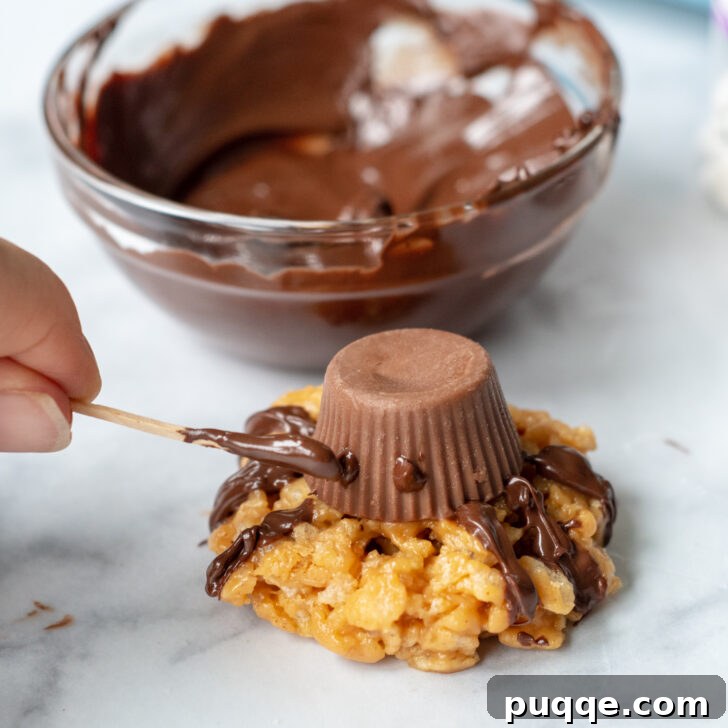 Ghoulishly Easy No-Bake Spider Treats 8 A toothpick applying small chocolate dots to the peanut butter cup, serving as adhesive for the candy eyeballs on a spider cookie.