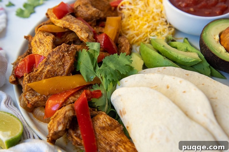 A close-up view of perfectly cooked Instant Pot chicken fajitas, showcasing the tender chicken, colorful peppers, and onions, ideal for a hearty meal.