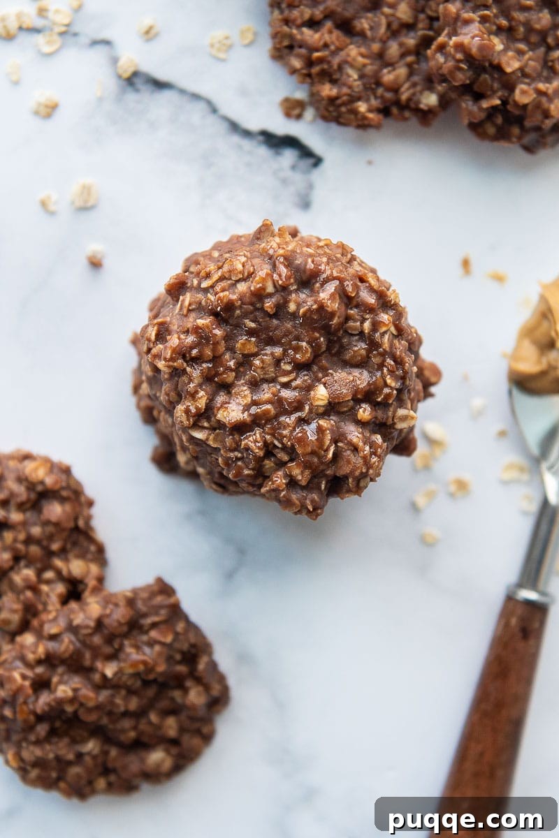 Easy 10-Minute No-Bake Gluten-Free Preacher Cookies 7 overhead shot of stack of preacher cookies with a spoon of peanut butter laying next to it