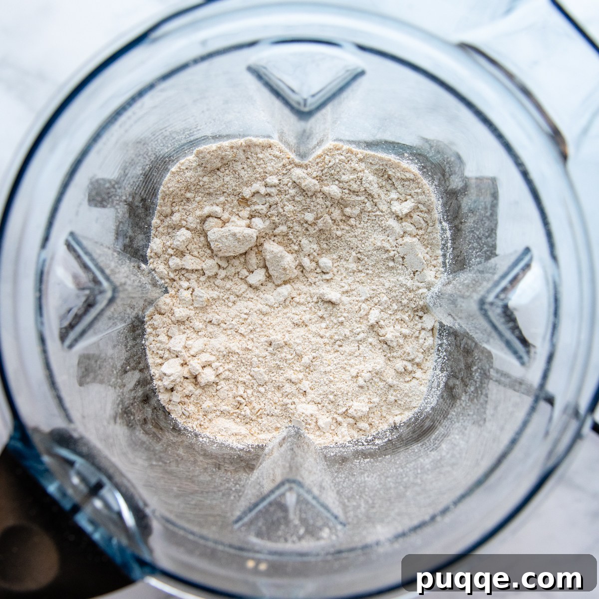 Oat flour in a blender after the oats have been processed into a fine powder.