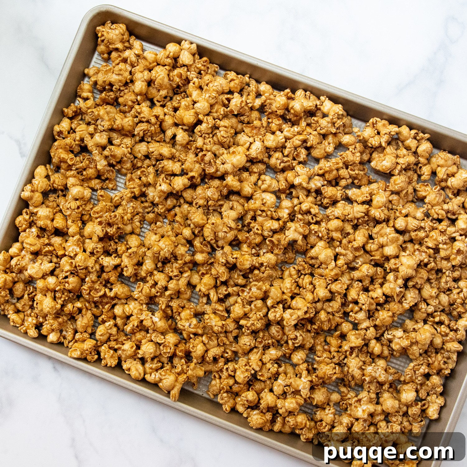 Mom's Go-To Microwave Caramel Popcorn 5 the caramel corn laid out on a baking sheet.
