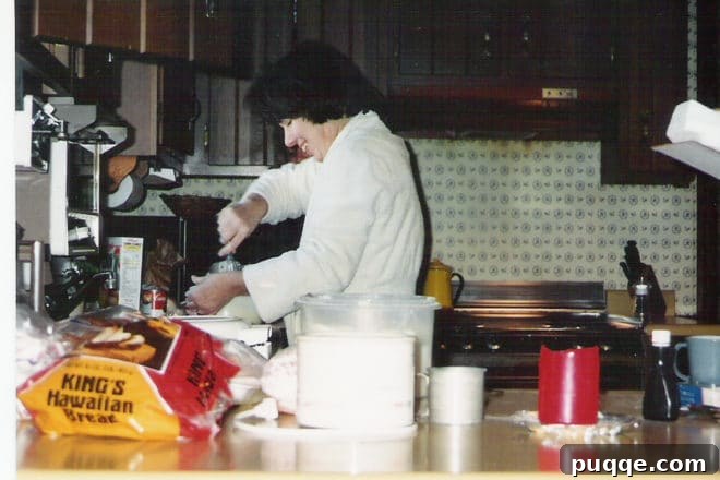A nostalgic photo of my mom in her robe, a familiar sight in our bustling kitchen during the holidays.