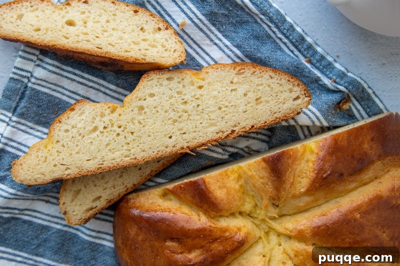 Baking Gluten Free Challah Made Easy 10 Beautiful slices of gluten-free challah bread arranged neatly on a blue towel, ready to be served.