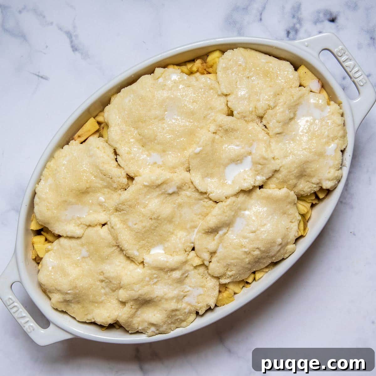 Easy Gluten Free Apple Cobbler with Fluffy Biscuit Topping 7 biscuit dough on top of apple filling.