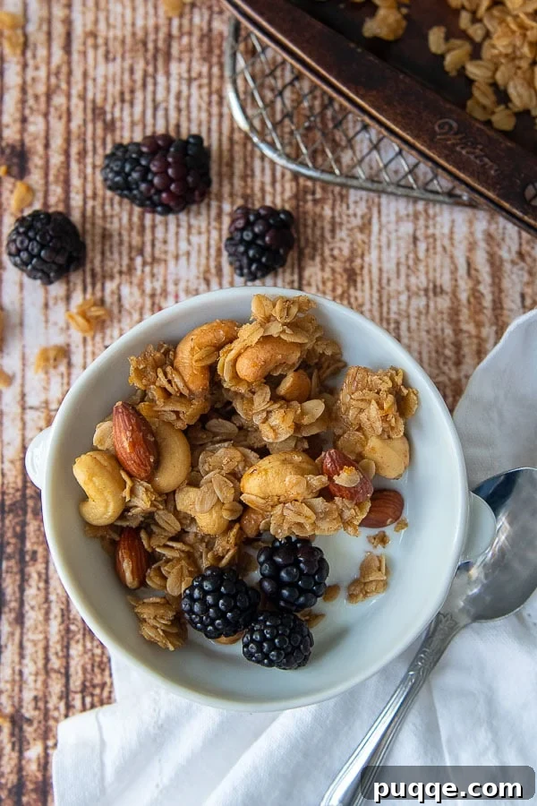 Craft Your Own Gluten-Free Granola 2 A bowl of homemade granola with milk and fresh berries, showcasing its chunky texture and delicious appearance.