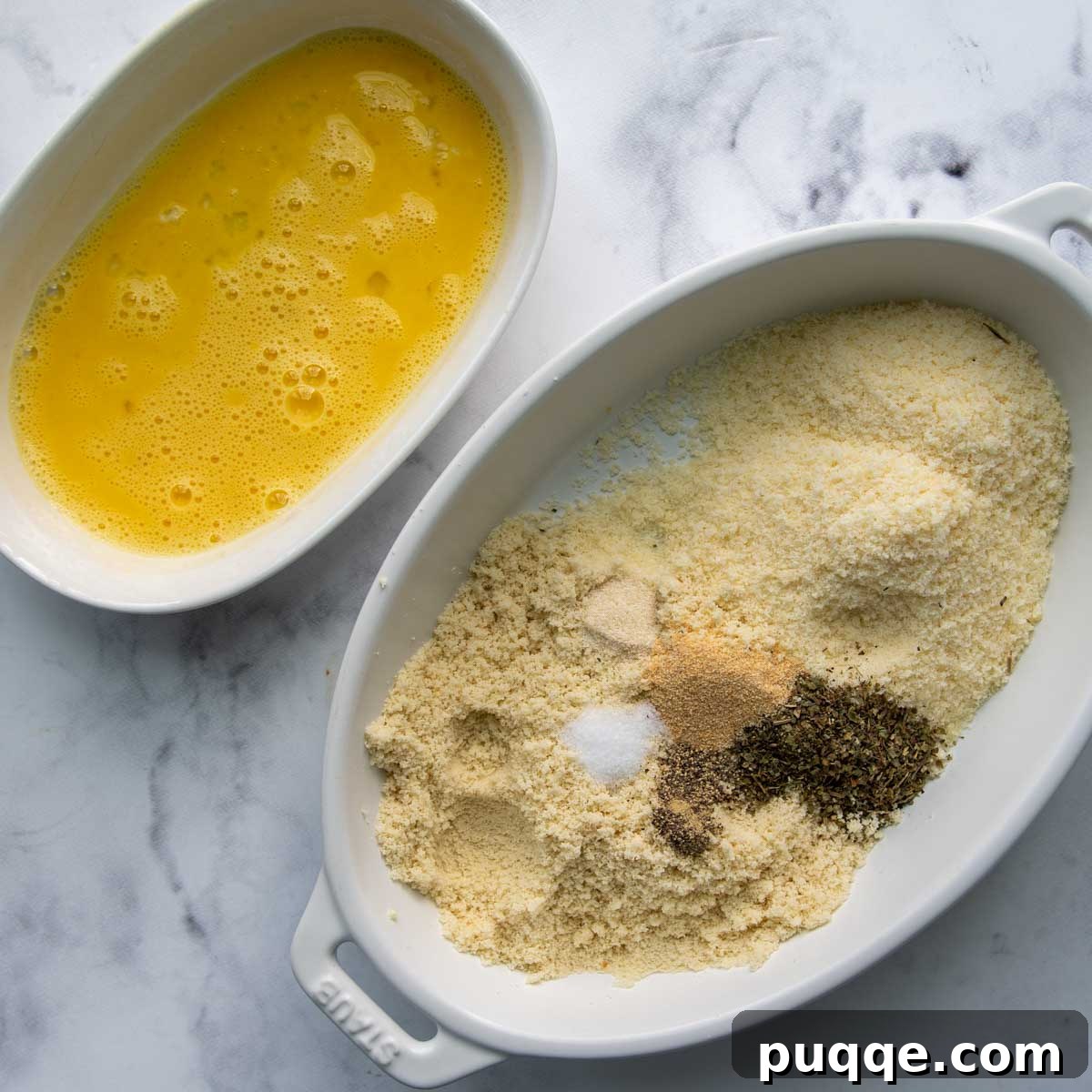 The breading mixture in one bowl and whisked egg in another, ready for coating.