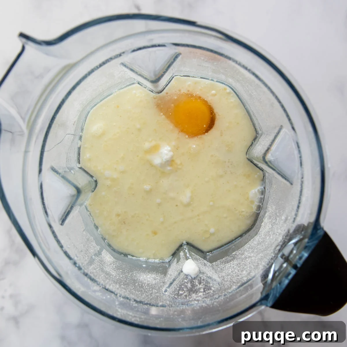 egg and milk added to the blender with oat flour, ready for blending