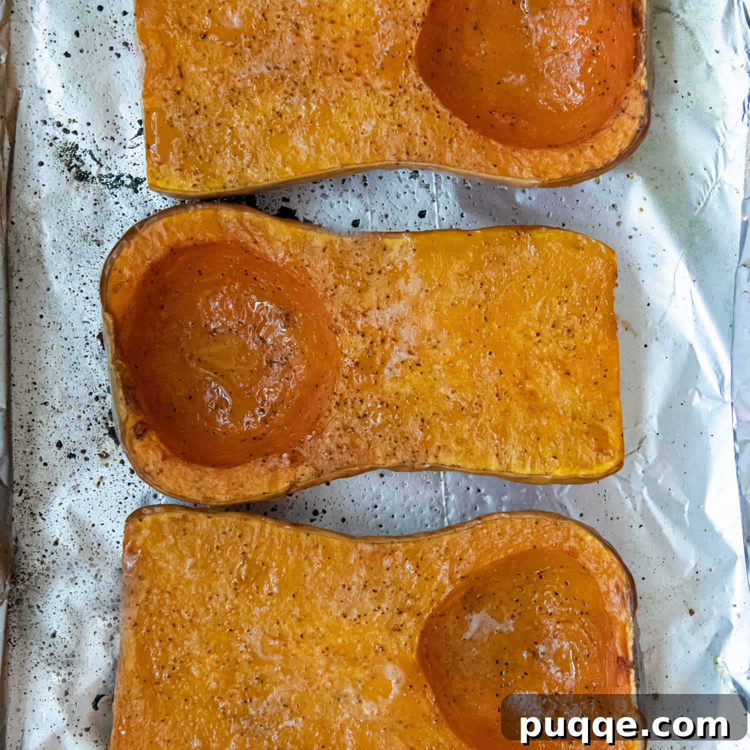 The Ultimate Panera Style Butternut Squash Soup Homemade Perfection 3 roasted squash on a baking sheet.