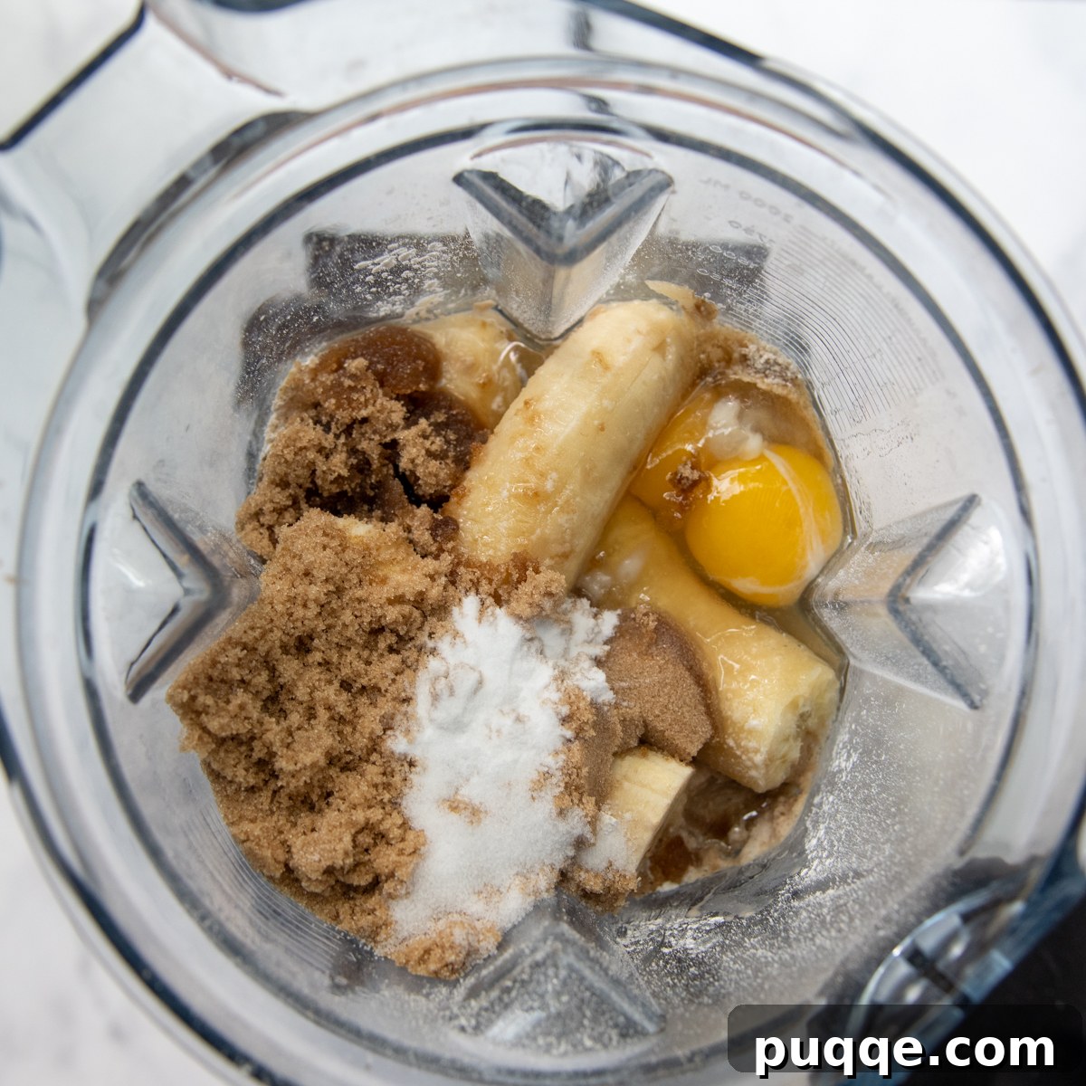 Quick Moist Oat Flour Banana Bread 4 a blender with all the ingredients placed in.