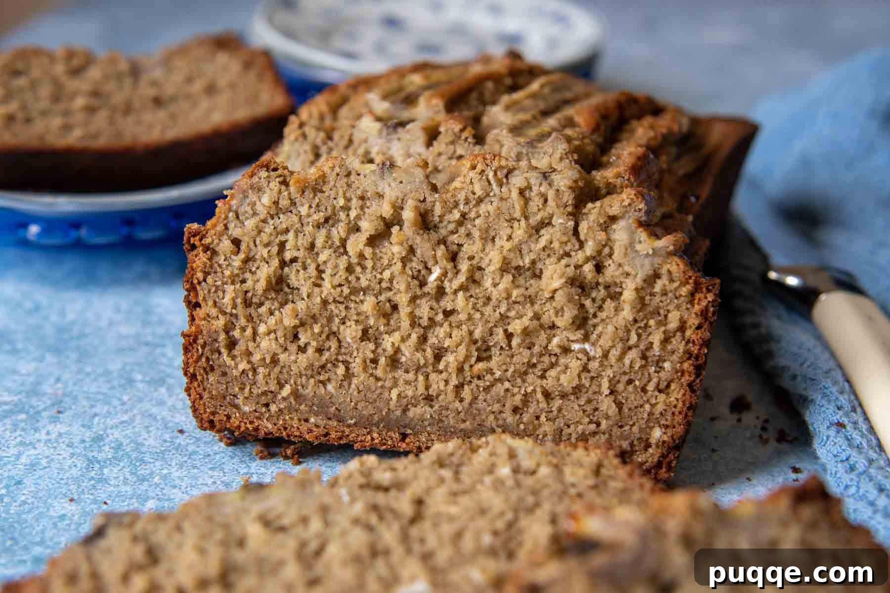 Quick Moist Oat Flour Banana Bread 7 a sliced open bread on a blue background