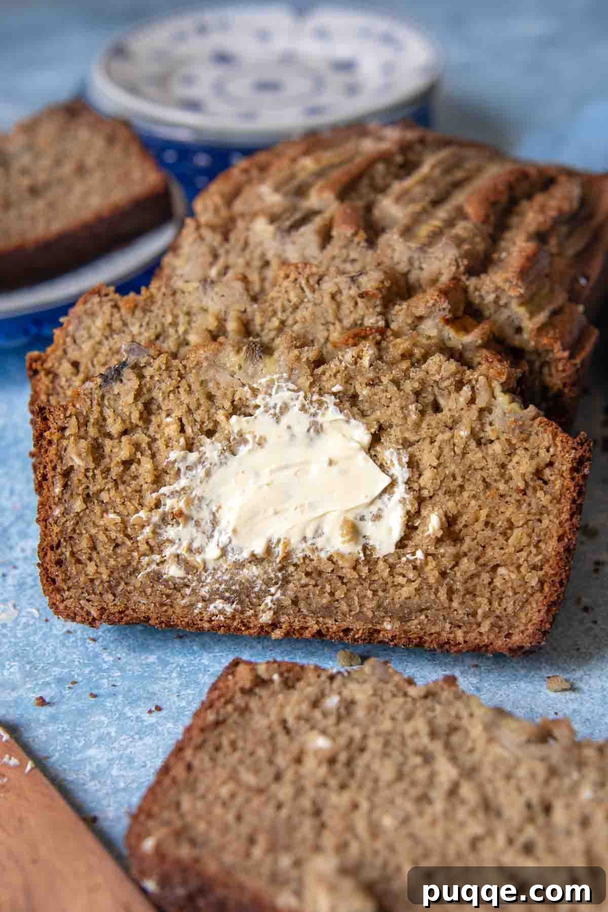 Quick Moist Oat Flour Banana Bread 8 a slice of bread with melted butter spread on