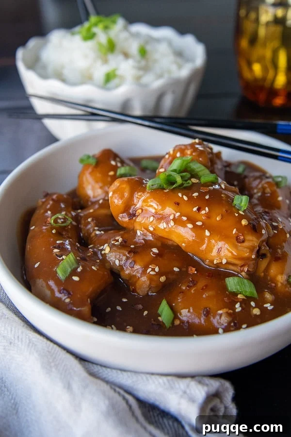 Wallet-Friendly Gluten-Free Meals: 40+ Easy Ideas 13 Side angle shot of succulent Asian chicken thighs, with chopsticks resting beside the bowl.