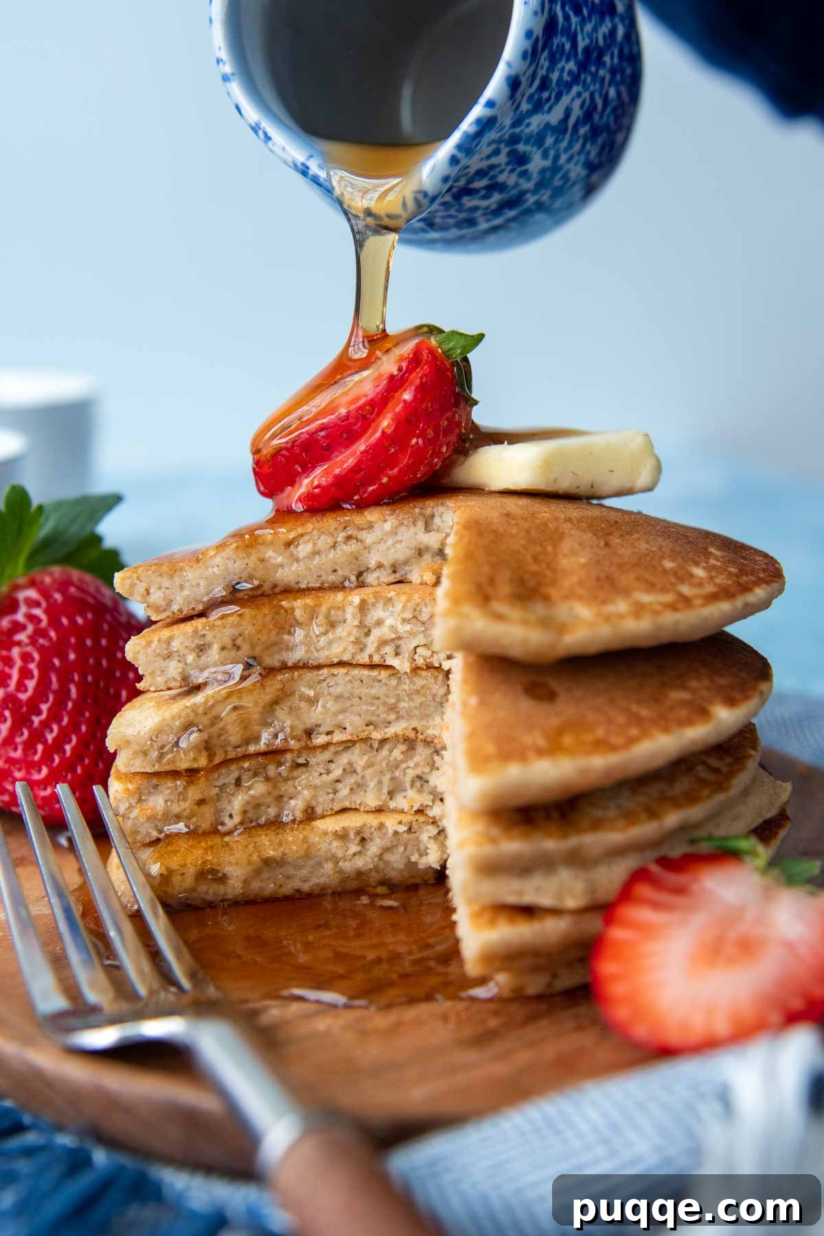 Wallet-Friendly Gluten-Free Meals: 40+ Easy Ideas 29 A delightful stack of cut pancakes, topped with a fresh strawberry and drizzled with syrup.