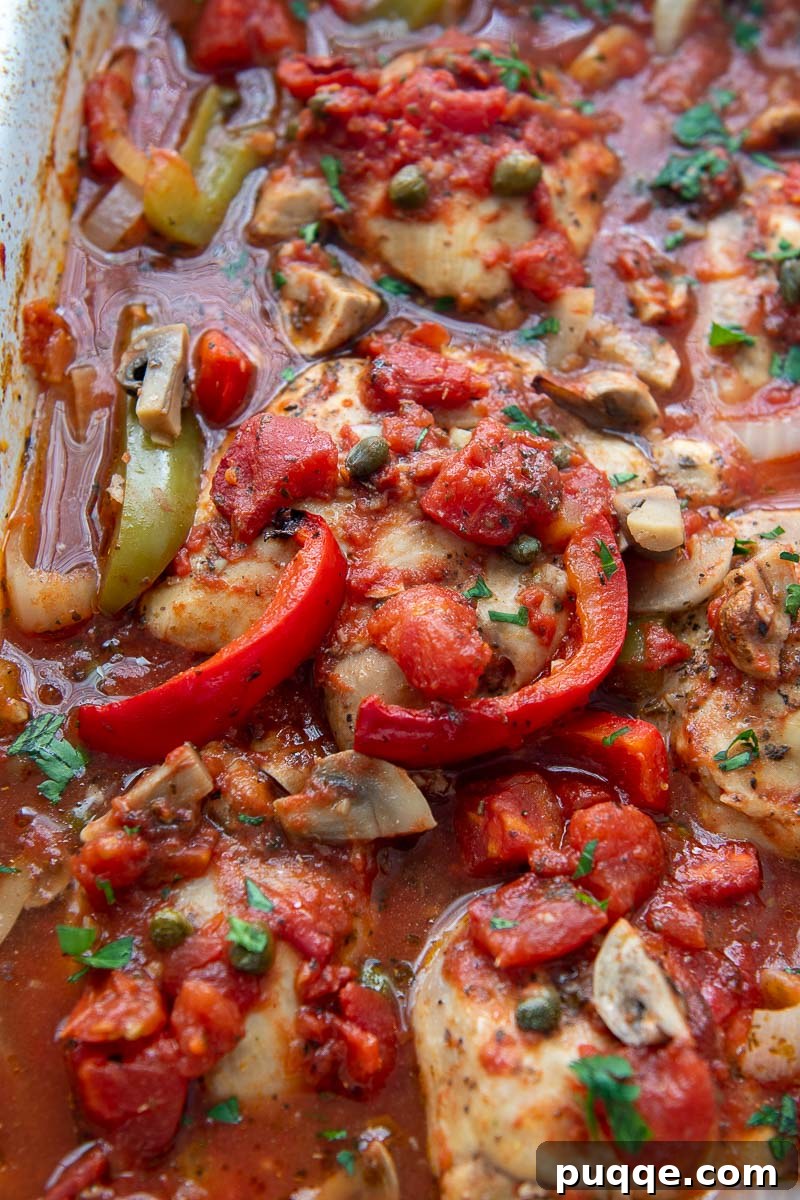 Wallet-Friendly Gluten-Free Meals: 40+ Easy Ideas 5 Close-up view of baked chicken cacciatore, showing tender chicken with colorful peppers, mushrooms, and onions in a rich tomato sauce.