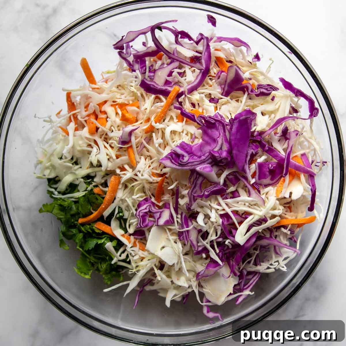 Flavorful Gluten Free Blackened Fish Tacos Ready in 30 6 Coleslaw ingredients mixed in a glass bowl.