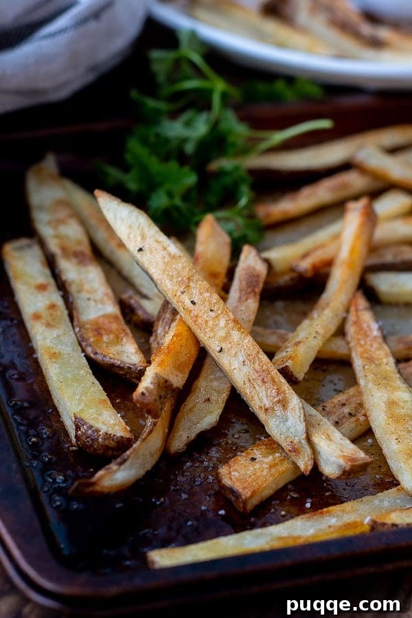 Foolproof Crispy Homemade Oven Fries 6 a close up of crispy oven fries on a baking sheet