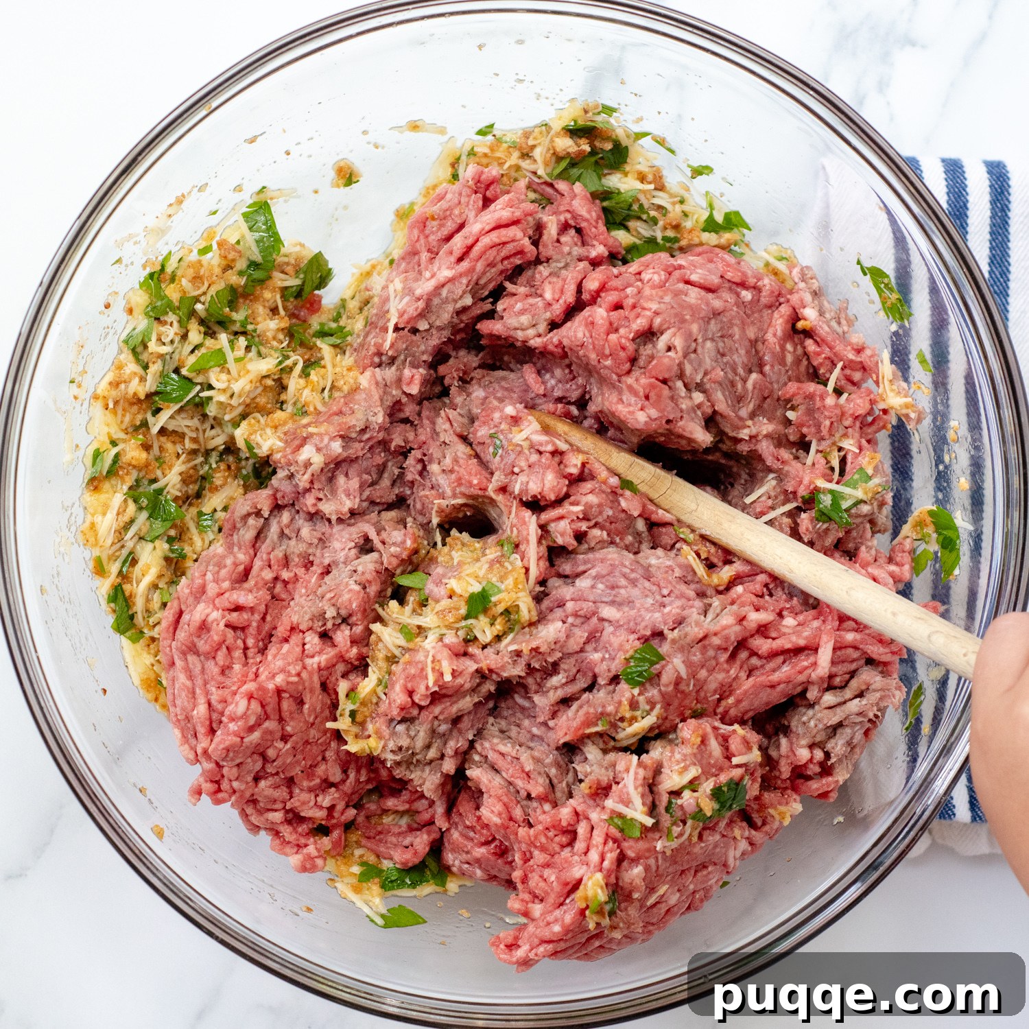 ground beef in a bowl with meatloaf ingredients.
