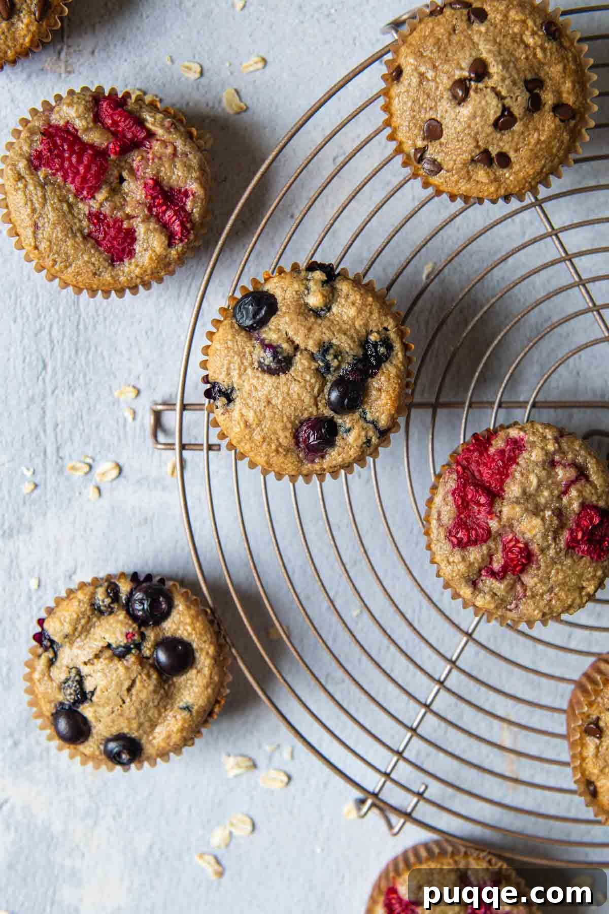 Pillowy 5-Minute Gluten-Free Oat Muffins 2 An inviting overhead shot of warm, freshly baked oat flour muffins arranged on a circular cooling rack, ready to be enjoyed.