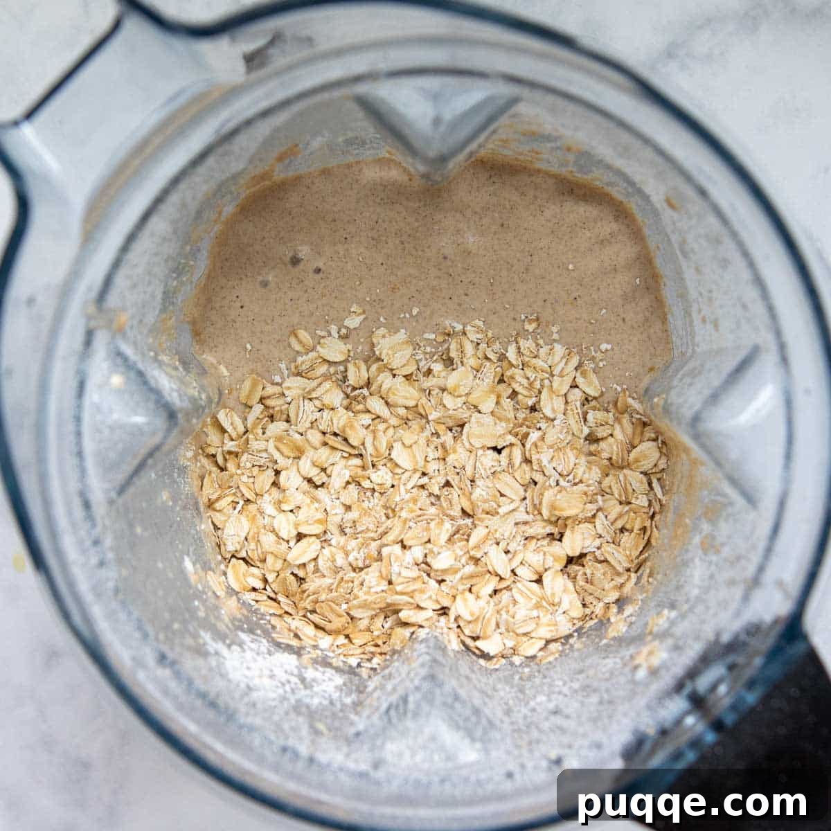 Pillowy 5-Minute Gluten-Free Oat Muffins 5 The remaining whole oats are being added to the blended muffin batter for texture before baking.