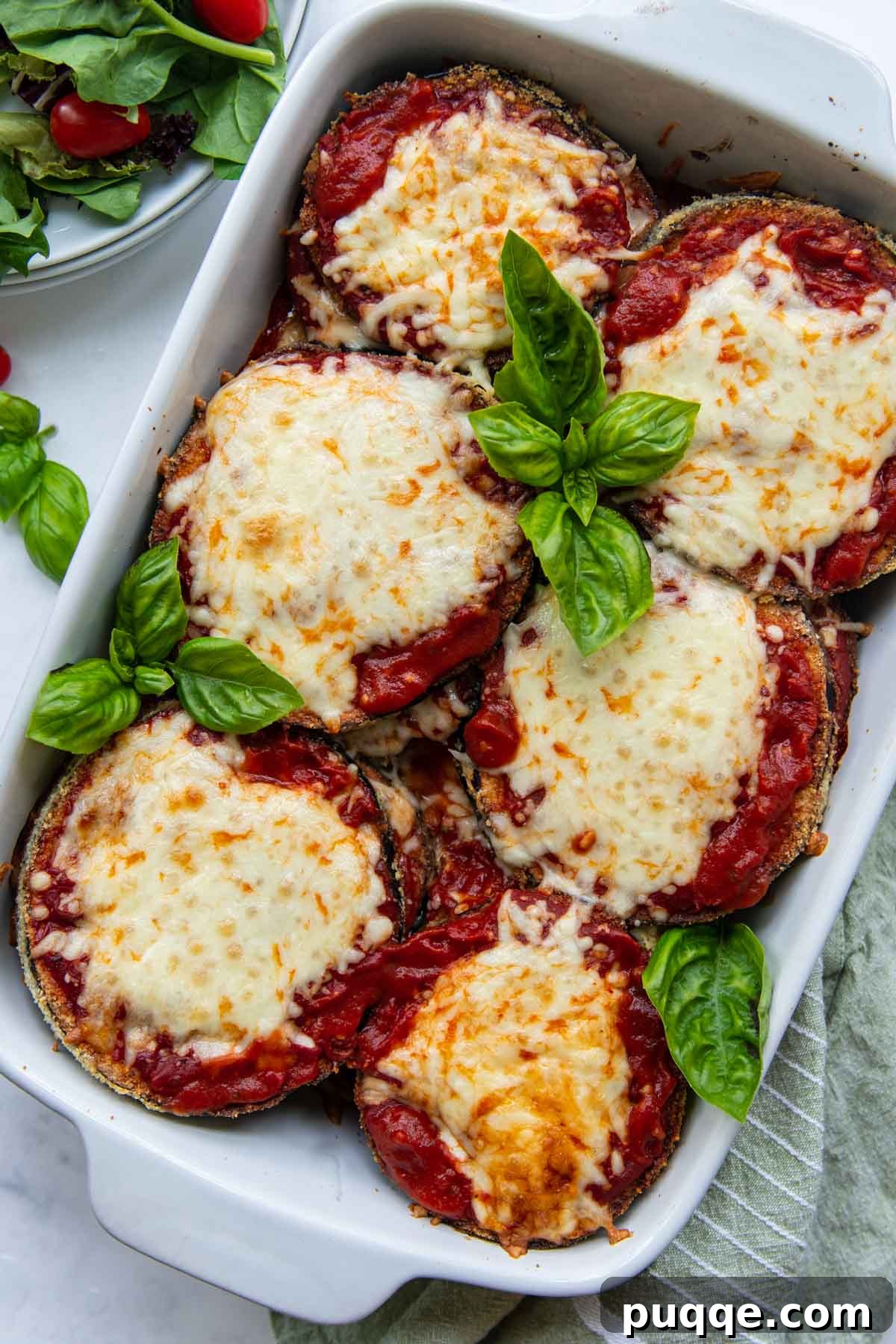 Crunchy Oven-Baked Gluten-Free Eggplant Parmesan 3 overhead shot of eggplant parm in a white baking dish with a salad next to it