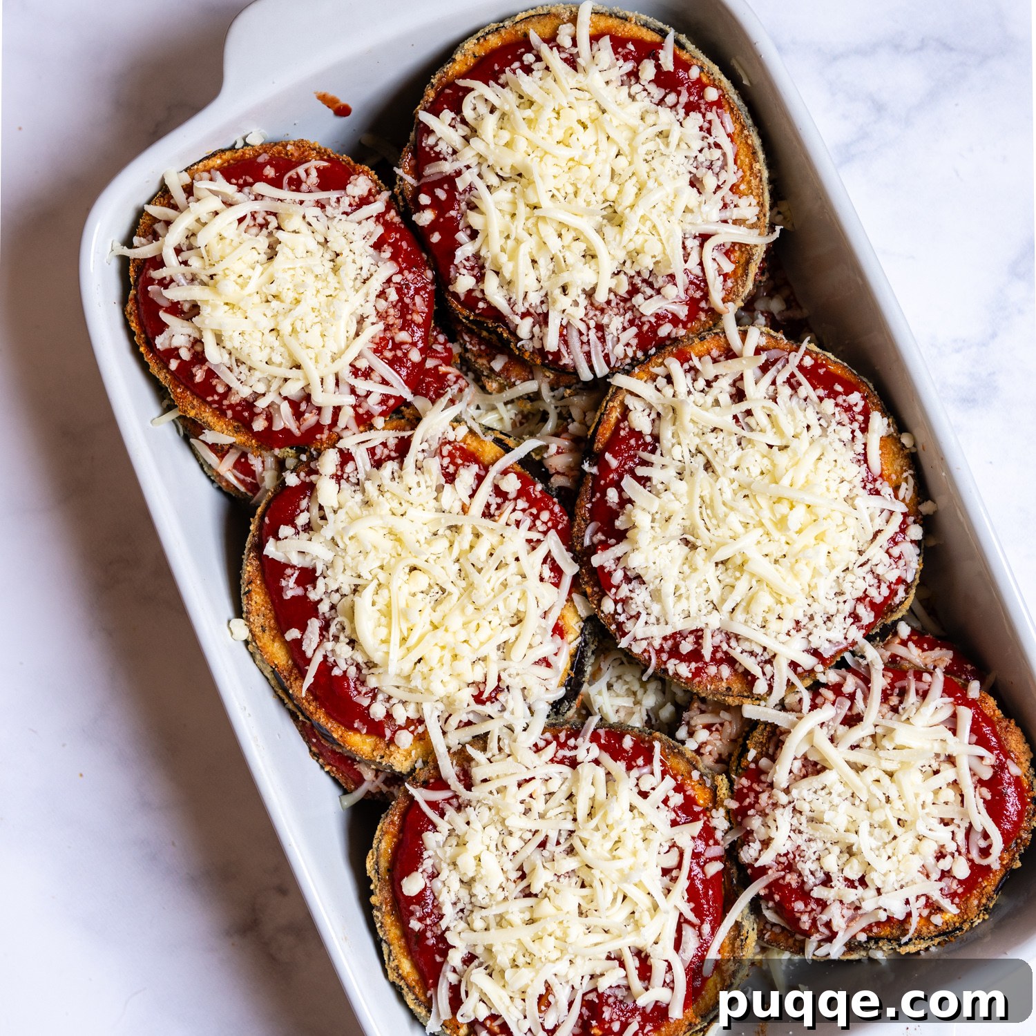 Crunchy Oven-Baked Gluten-Free Eggplant Parmesan 7 the assembled casserole before baking with grated cheese on top.