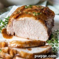 Fall-Apart Tender Instant Pot Pork 7 A sliced pork roast with gravy over the top