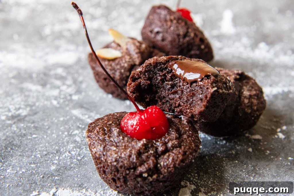 Irresistible Chocolate Financiers 6 a financier with a bite taken out and melted chocolate dripping down