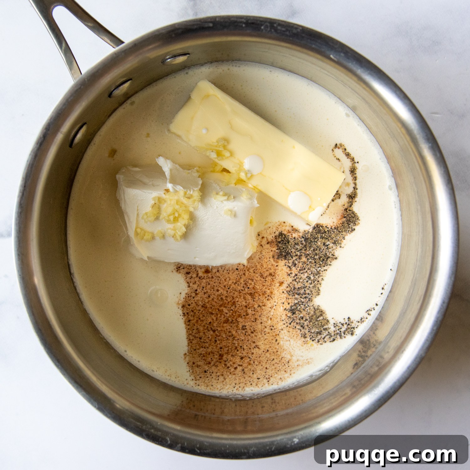 Quick and Creamy Gluten-Free Alfredo in 10 Minutes 3 All the cold ingredients for the Alfredo sauce (butter, heavy cream, cream cheese, garlic, spices) placed in a saucepan before heating.