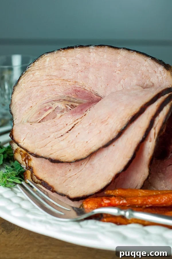 A beautifully glazed baked ham surrounded by an array of delicious side dishes, perfect for holiday gatherings or a ham steak dinner. The table is set, hinting at a festive occasion.