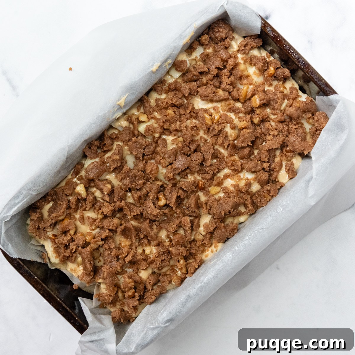 Cozy Gluten-Free Apple Cinnamon Crumble Bread 6 unbaked apple bread in a loaf pan, generously topped with streusel, ready for the oven