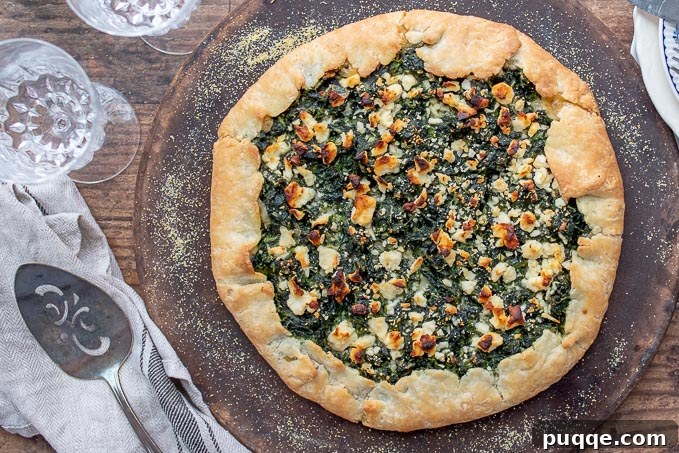 Seasonal Vegetable Harvest Tart 3 An overhead shot of a freshly baked vegetable tart resting on a rustic baking stone, with a serving spatula beside it, highlighting its inviting golden crust.