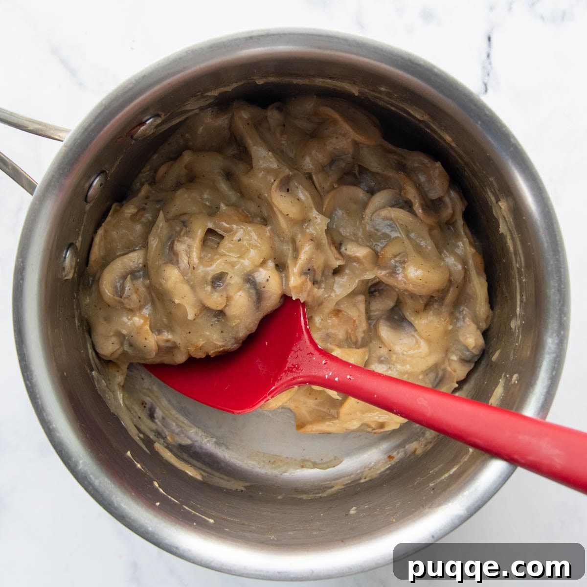 Hearty Homestyle Gluten-Free Green Bean Bake 4 Thickened, creamy homemade mushroom sauce in a saucepan.
